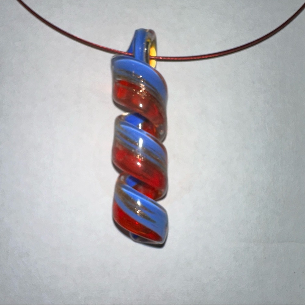 Glass pendant on the wire. New never worn.